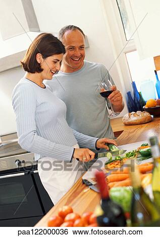 Woman chopping vegetables, man holding glass of wine View Large Photo Image Stock Photograph - Woman chopping vegetables, man holding glass of wine. Fotosearch