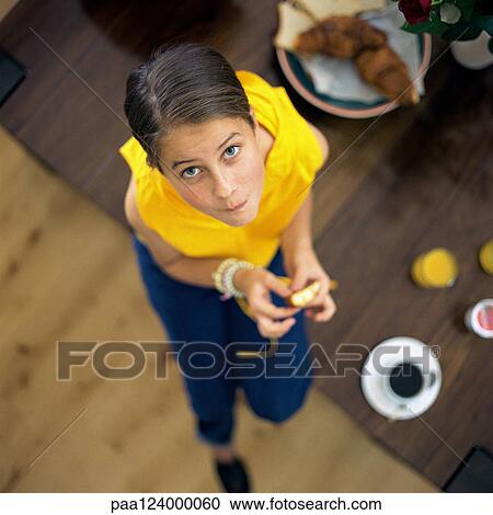 Child sitting on edge of table, looking at camera, high angle view View Large Photo Image Stock Image - Child sitting on edge of table, looking at camera, high angle view. Fotosearch