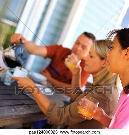 Couple and daughter having breakfast outside View Large Photo Image Stock Image - Couple and daughter having breakfast outside. Fotosearch