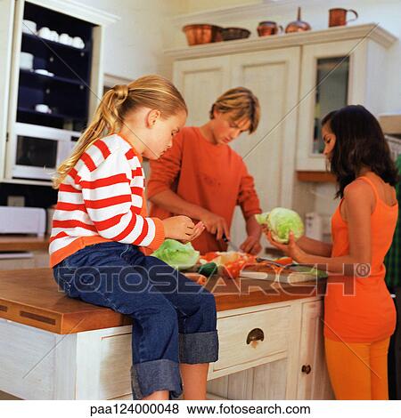 Family cooking in kitchen View Large Photo Image Stock Photo - Family cooking in kitchen. Fotosearch