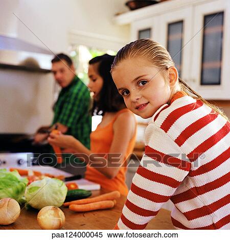 Family cooking, little girl looking over shoulder View Large Photo Image Stock Photography - Family cooking, little girl looking over shoulder. Fotosearch