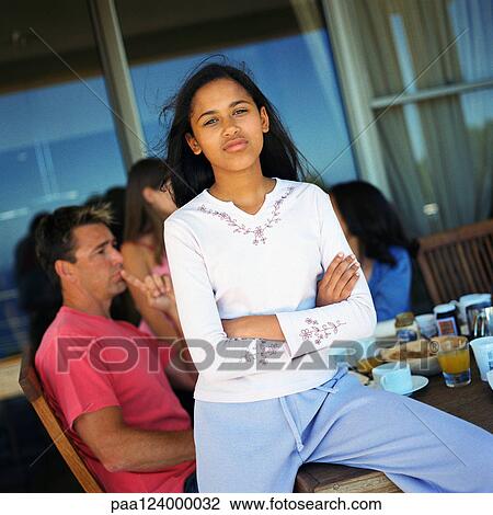Family having breakfast, girl sitting on table View Large Photo Image Stock Image - Family having breakfast, girl sitting on table. Fotosearch