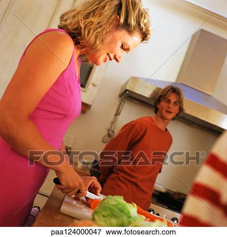 Stock Photo - Family standing in kitchen. Fotosearch