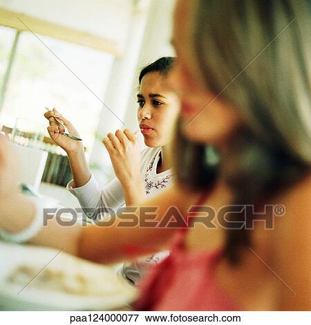 Girls eating, blurred foreground View Large Photo Image Stock Photo - Girls eating, blurred foreground. Fotosearch
