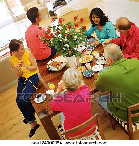 Picture - Grandparents, parents and children at table, high angle view. Fotosearch