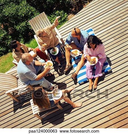 Grandparents, parents and children eating outside, elevated view View Large Photo Image Stock Image - Grandparents, parents and children eating outside, elevated view. Fotosearch