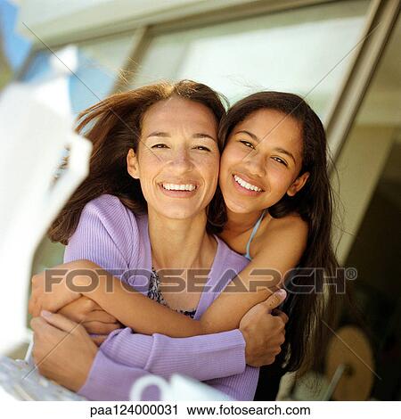 Mother and daughter hugging, portrait View Large Photo Image Stock Image - Mother and daughter hugging, portrait. Fotosearch