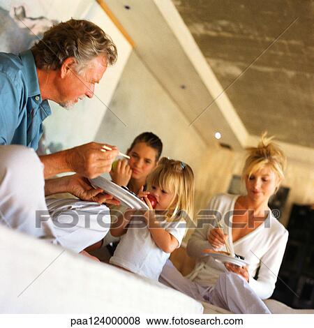 Parents and children eating View Large Photo Image Stock Photo - Parents and children eating. Fotosearch