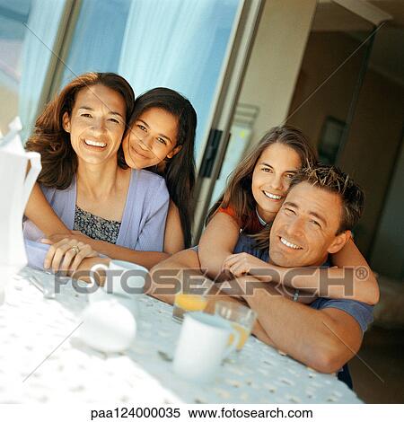 Parents being hugged by daughters View Large Photo Image Stock Photography - Parents being hugged by daughters. Fotosearch