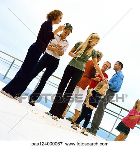 People standing and holding glasses, outside View Large Photo Image Stock Photo - People standing and holding glasses, outside. Fotosearch