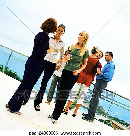People standing and holding glasses, outside View Large Photo Image Stock Photograph - People standing and holding glasses, outside. Fotosearch