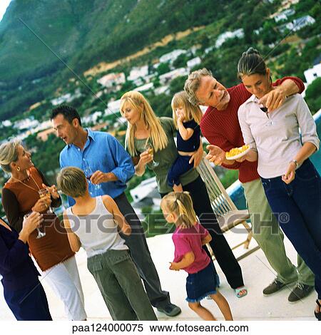 People standing and holding glasses, outside View Large Photo Image Stock Photography - People standing and holding glasses, outside. Fotosearch
