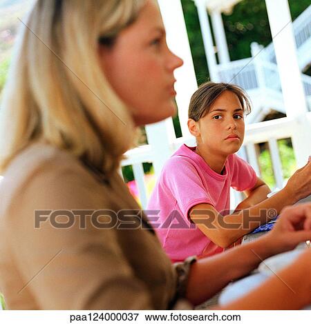Woman and girl sitting outside, blurred View Large Photo Image Stock Photo - Woman and girl sitting outside, blurred. Fotosearch
