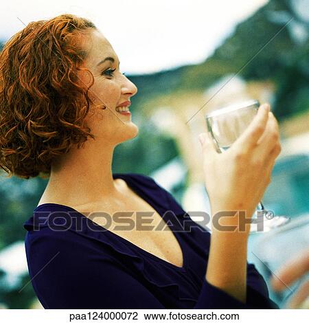 Woman holding glass, side view, portrait View Large Photo Image Stock Image - Woman holding glass, side view, portrait. Fotosearch
