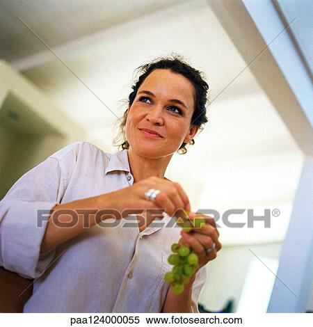 Woman holding grapes, low angle view View Large Photo Image Stock Photography - Woman holding grapes, low angle view. Fotosearch