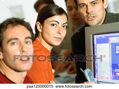 Adults grouped around computer, close-up View Large Photo Image Stock Photography - Adults grouped around computer, close-up. Fotosearch