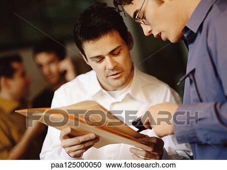 Businessmen interacting in office, close-up View Large Photo Image Stock Image - Businessmen interacting in office, close-up. Fotosearch