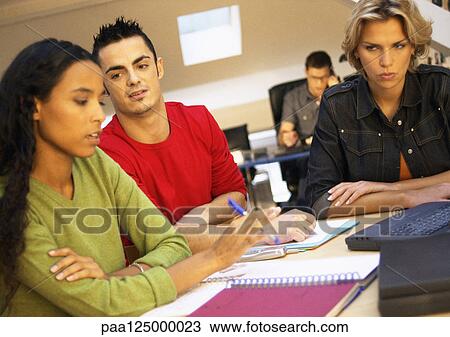 Co-workers having meeting in office View Large Photo Image Stock Image - Co-workers having meeting in office. Fotosearch