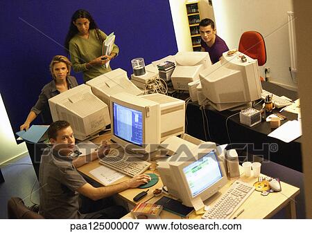 Four people in office, high angle view, portrait View Large Photo Image Stock Photo - Four people in office, high angle view, portrait. Fotosearch