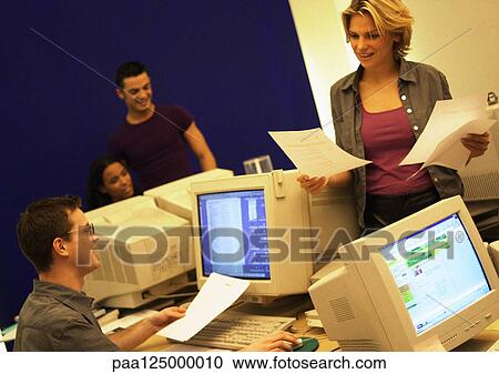 Four people working in office View Large Photo Image Stock Image - Four people working in office. Fotosearch