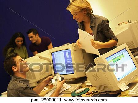 Stock Image - Four people working in office. Fotosearch