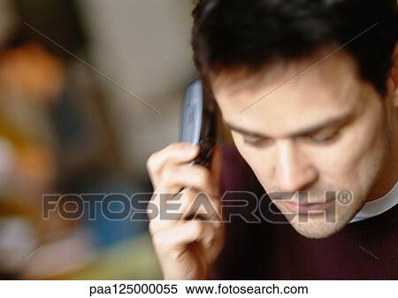 Stock Photography - Man using cell phone, close-up. Fotosearch
