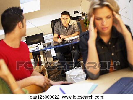Men talking in office, woman holding head View Large Photo Image Stock Image - Men talking in office, woman holding head. Fotosearch
