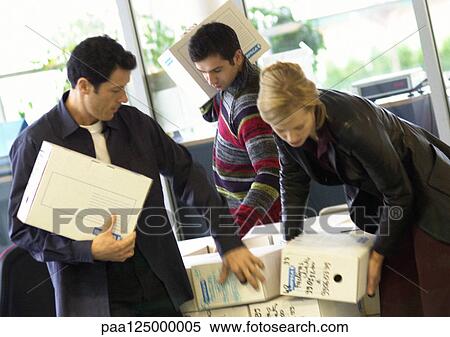 Stock Photography - Two men and woman carrying boxes. Fotosearch