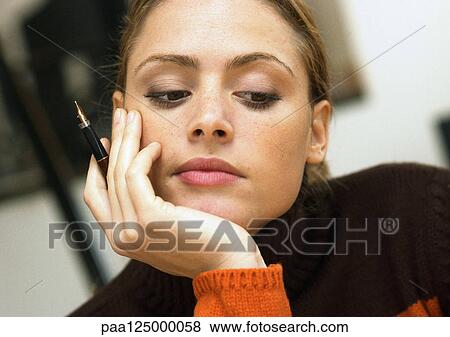 Stock Photo - Woman with hand under chin, close-up. Fotosearch