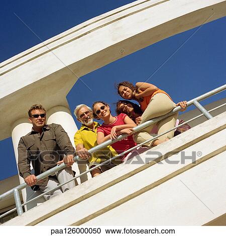 Family leaning on railing, low angle view View Large Photo Image Stock Image - Family leaning on railing, low angle view. Fotosearch