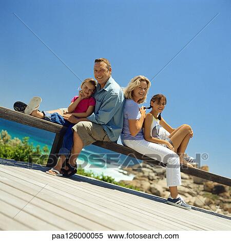 Stock Photography - Family portrait in front of sea. Fotosearch