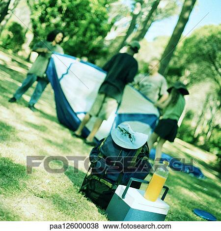 Stock Photo - Family setting up tent. Fotosearch