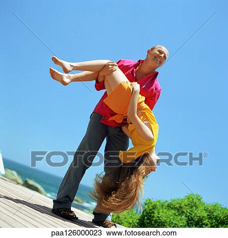 Father holding daughter upside down, outside View Large Photo Image Stock Image - Father holding daughter upside down, outside. Fotosearch