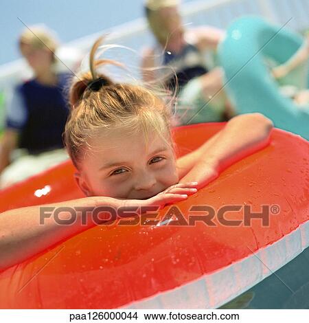 Picture - Girl in inflatable ring, smiling, close-up. Fotosearch