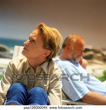 Stock Photography - Mature couple sitting outside. Fotosearch