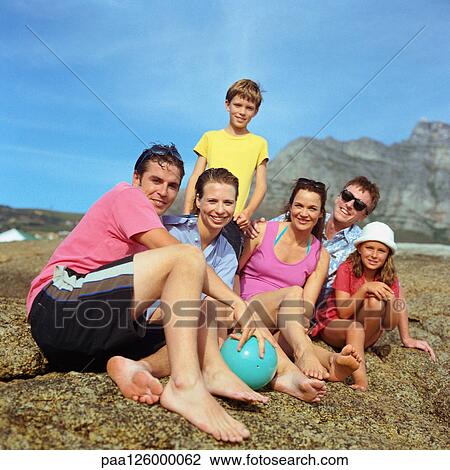 Stock Image - Two couples and children outside, smiling, portrait. Fotosearch