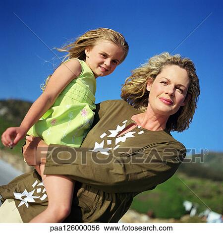Woman carrying little girl, portrait View Large Photo Image Stock Photograph - Woman carrying little girl, portrait. Fotosearch