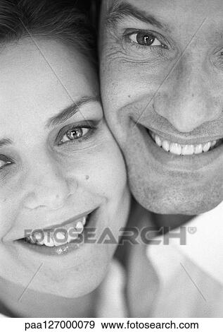 Stock Photo - Couple cheek to cheek, close-up, b&w. Fotosearch
