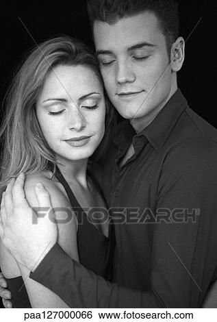 Couple hugging, eyes closed, b&w View Large Photo Image Stock Photograph - Couple hugging, eyes closed, b&w. Fotosearch