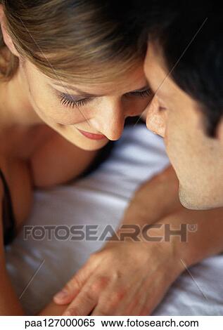 Couple lying face to face, close-up View Large Photo Image Stock Photography - Couple lying face to face, close-up. Fotosearch