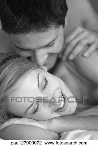 Couple lying on bed, close-up, b&w View Large Photo Image Stock Image - Couple lying on bed, close-up, b&w. Fotosearch