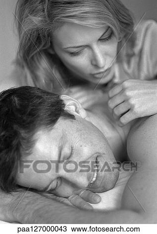 Man and woman lying on bed, close-up, b&w View Large Photo Image Stock Image - Man and woman lying on bed, close-up, b&w. Fotosearch
