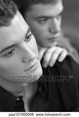 Man holding other man's shoulder, close-up, b&w View Large Photo Image Stock Photo - Man holding other man's shoulder, close-up, b&w. Fotosearch