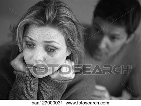 Man standing behind tearful woman, close-up, b&w View Large Photo Image Stock Image - Man standing behind tearful woman, close-up, b&w. Fotosearch