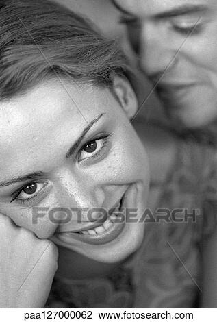 Man standing behind woman smiling, close-up, b&w View Large Photo Image Stock Image - Man standing behind woman smiling, close-up, b&w. Fotosearch