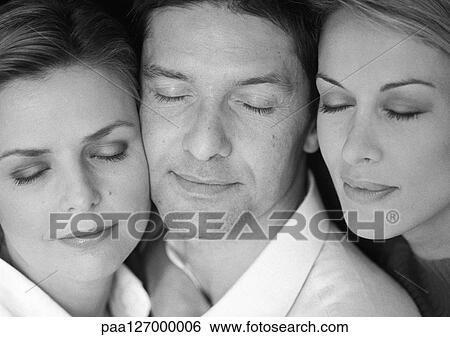 Two women and man side by side, eyes closed, close-up, b&w View Large Photo Image Stock Photograph - Two women and man side by side, eyes closed, close-up, b&w. Fotosearch