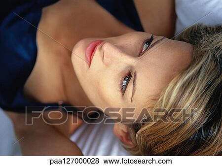 Woman lying down, close-up View Large Photo Image Stock Photo - Woman lying down, close-up. Fotosearch