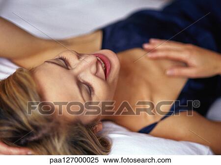 Woman lying down, smiling View Large Photo Image Stock Photography - Woman lying down, smiling. Fotosearch