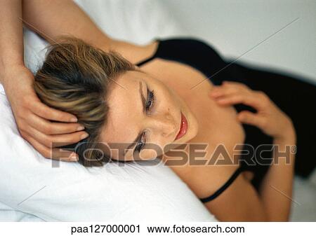 Woman lying on bed View Large Photo Image Stock Image - Woman lying on bed. Fotosearch