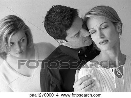 Woman standing behind couple, b&w View Large Photo Image Picture - Woman standing behind couple, b&w. Fotosearch